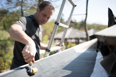 Compress the EPDM membrane onto the surface with a silicone roller
